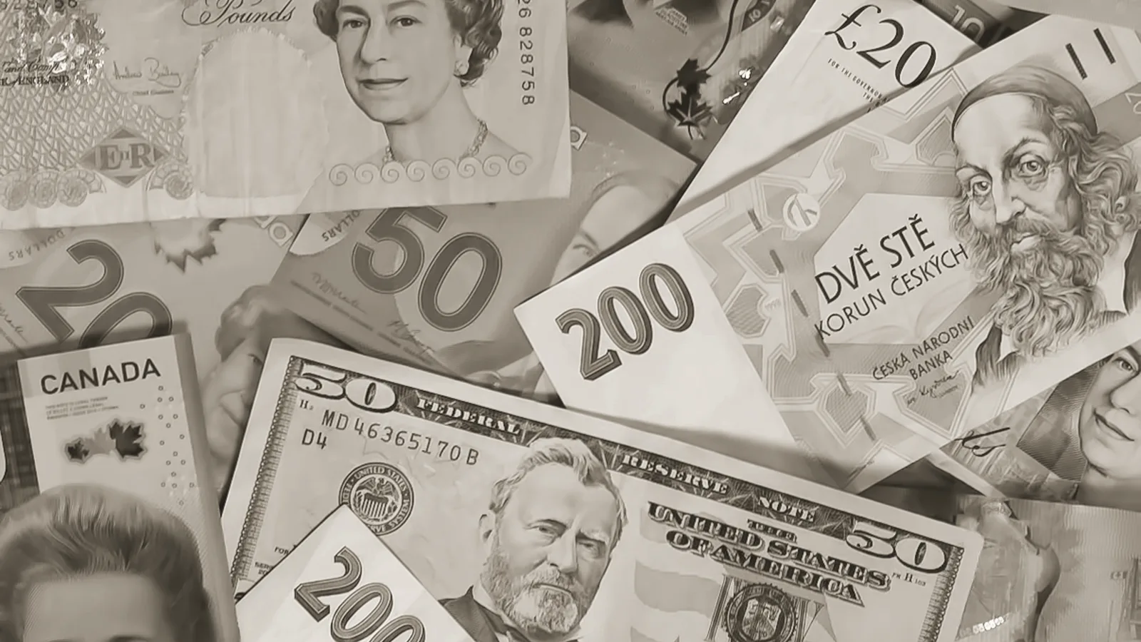 Scattered international banknotes in black and white, including a US fifty-dollar bill, sterling notes, and other national notes.